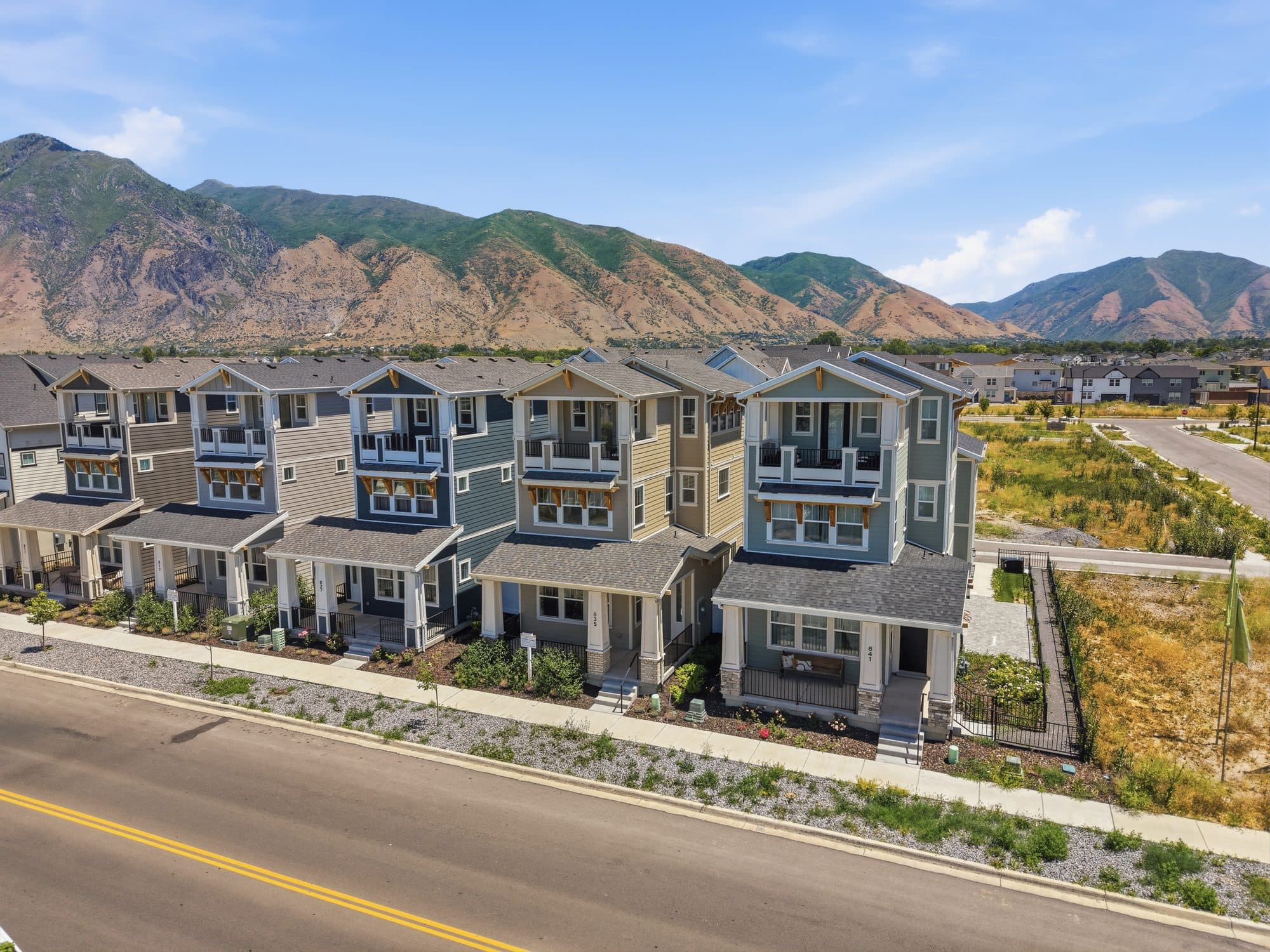 A row of new Iron Oak Cottages at Huntington Ranch, framed by the Wasatch mountains.