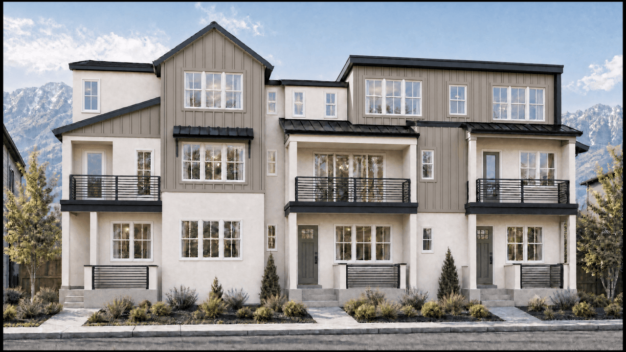 The Towns, a three-unit townhome building in stucco and board-and-batten against the mountains.